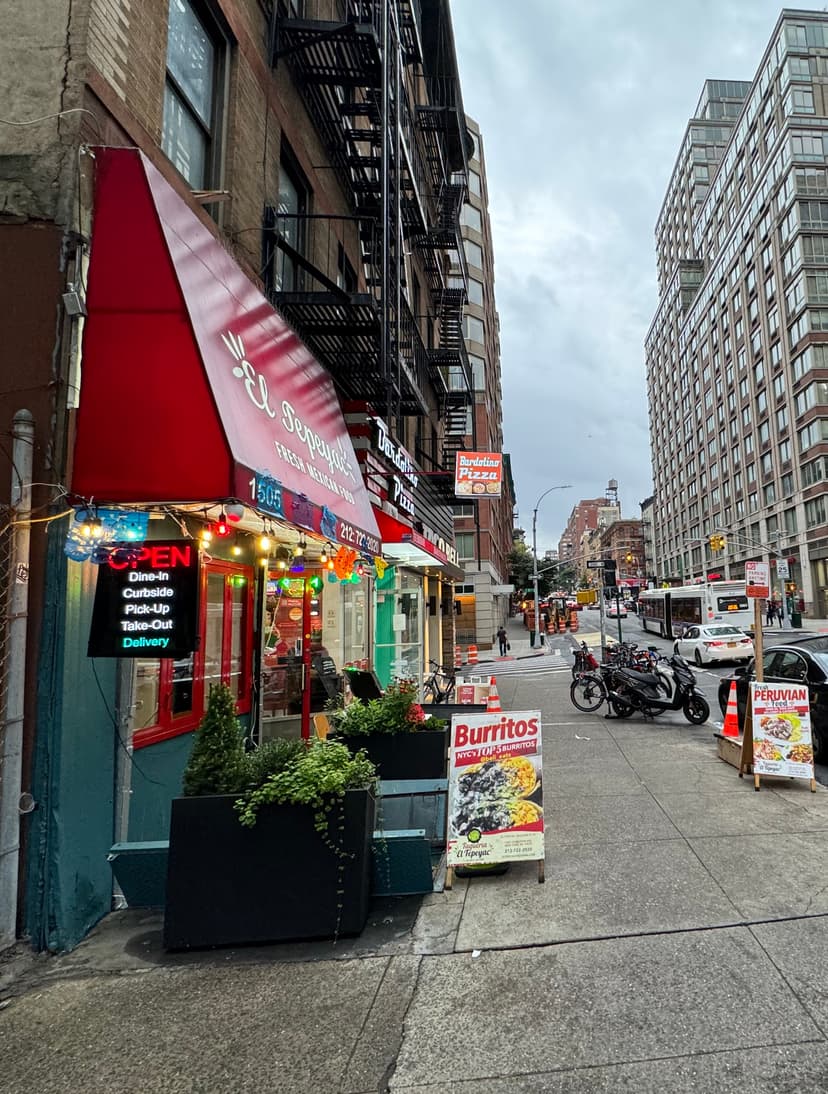 A picture of a Mexican restaurant along a road on a cloudy day